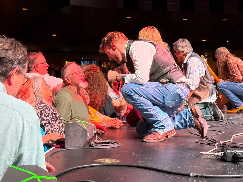 Performer interacting with seated audience member